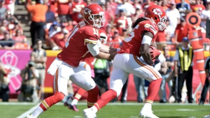 Oct 11, 2015; Kansas City, MO, USA; Kansas City Chiefs quarterback Alex Smith (11) hands off to running back Jamaal Charles (25) during the first half against the Chicago Bears at Arrowhead Stadium. Mandatory Credit: Denny Medley-USA TODAY Sports