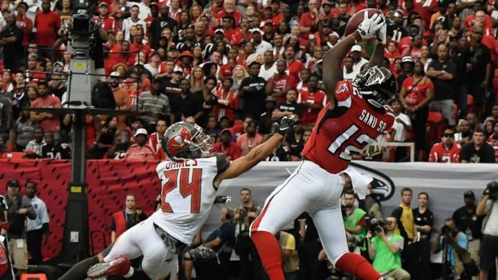 Sep 11, 2016; Atlanta, GA, USA; Atlanta Falcons wide receiver Mohamed Sanu (12) catches a touchdown pass over Tampa Bay Buccaneers defensive back Brent Grimes (24) running back Charles Sims (34) during the first half at the Georgia Dome. Mandatory Credit: Dale Zanine-USA TODAY Sports