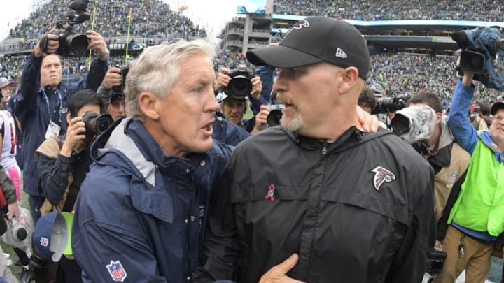 Oct 16, 2016; Seattle, WA, USA; Seattle Seahawks coach Pete Carroll (left) shakes hands with Atlanta Falcons coach Dan Quinn after a NFL football game at CenturyLink Field. The Seahawks defeated the Falcons 26-24. Mandatory Credit: Kirby Lee-USA TODAY Sports