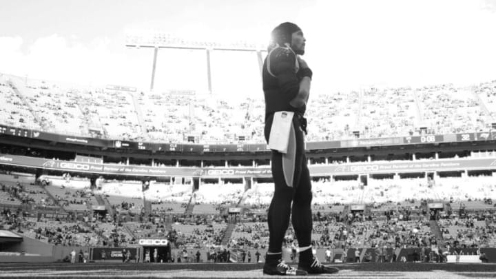 CHARLOTTE, NORTH CAROLINA - DECEMBER 26: (EDITORS NOTE: IMAGE CONVERTED TO BLACK AND WHITE) Cam Newton #1 of the Carolina Panthers watches from the sideline during the final minute of the team's final home game of the season against the Tampa Bay Buccaneers at Bank of America Stadium on December 26, 2021 in Charlotte, North Carolina. (Photo by Grant Halverson/Getty Images)