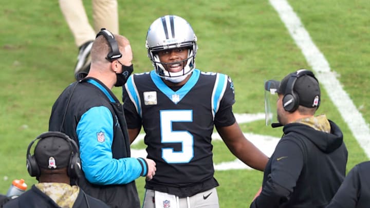 Nov 15, 2020; Charlotte, North Carolina, USA; Carolina Panthers quarterback Teddy Bridgewater (5) talks to head coach Matt Rhule and offensive coordinator Joe Brady in the second quarter at Bank of America Stadium. Mandatory Credit: Bob Donnan-USA TODAY Sports
