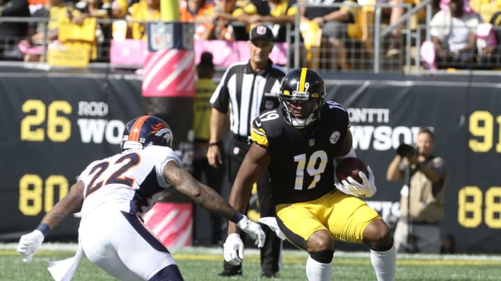 Oct 10, 2021; Pittsburgh, Pennsylvania, USA; Pittsburgh Steelers wide receiver JuJu Smith-Schuster (19) runs after a catch as Denver Broncos safety Kareem Jackson (22) defends during the second quarter at Heinz Field. Mandatory Credit: Charles LeClaire-USA TODAY Sports