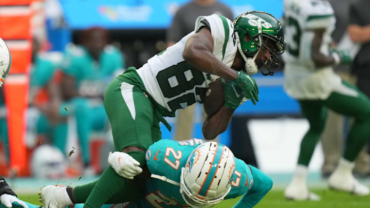 Dec 19, 2021; Miami Gardens, Florida, USA; Miami Dolphins cornerback Justin Coleman (27) tackles New York Jets wide receiver Jamison Crowder (82) during the second half at Hard Rock Stadium. Mandatory Credit: Jasen Vinlove-USA TODAY Sports