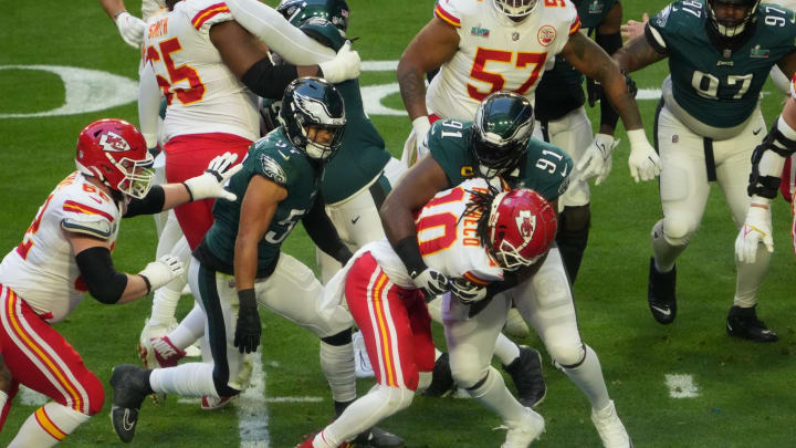 Feb 12, 2023; Glendale, AZ, USA; Kansas City Chiefs running back Isiah Pacheco (10) is tackled by Philadelphia Eagles defensive tackle Fletcher Cox (91) during the first quarter in Super Bowl LVII at State Farm Stadium. Mandatory Credit: Joe Rondone/The Republic via USA TODAY Sports