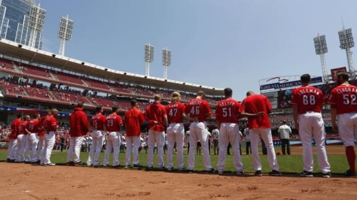 May 22, 2016; Cincinnati, OH, USA; The Cincinnati Reds stand on the field during the national anthem at the prior to their game against the Seattle Mariners at Great American Ball Park. Mandatory Credit: David Kohl-USA TODAY Sports