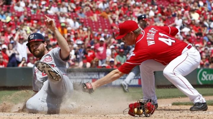Jun 5, 2016; Cincinnati, OH, USA; Washington Nationals second baseman Daniel Murphy (20) scores a run ahead of the tag from Cincinnati Reds relief pitcher Daniel Wright (41) during the fifth inning at Great American Ball Park. Mandatory Credit: David Kohl-USA TODAY Sports