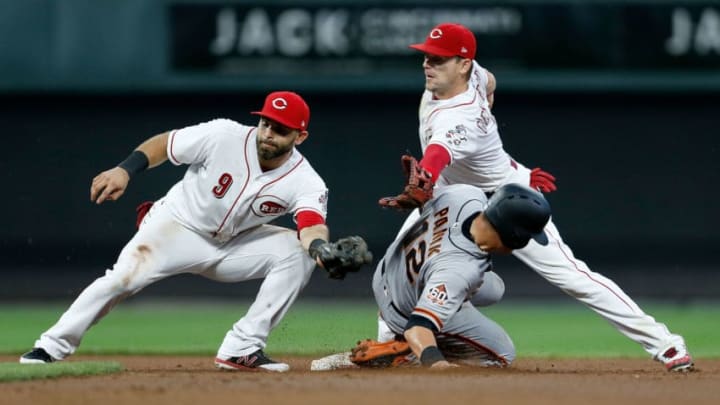CINCINNATI, OH - AUGUST 17: Joe Panik #12 of the San Francisco Giants slides past Jose Peraza #9 and Scooter Gennett #3 of the Cincinnati Reds to steal second base during the fifth inning at Great American Ball Park on August 17, 2018 in Cincinnati, Ohio. Cincinnati defeated San Francisco 2-1 in 11 innings. (Photo by Kirk Irwin/Getty Images)
