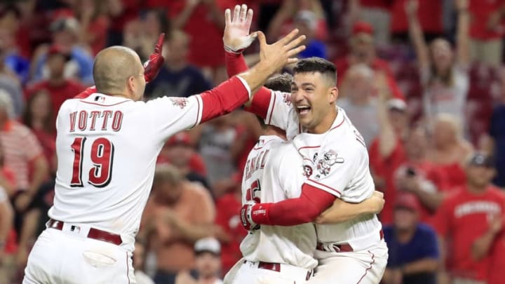 CINCINNATI, OHIO - JULY 02: Joey Votto #19 of the Cincinnati Reds celebrates with Nick Senzel #15 and Jose Iglesias #4 after the 5-4 win in 11 innings against the Milwaukee Brewers at Great American Ball Park on July 02, 2019 in Cincinnati, Ohio. Iglesias hit a game winning single that drove in Yasiel Puig #66 in the 11th inning. (Photo by Andy Lyons/Getty Images)