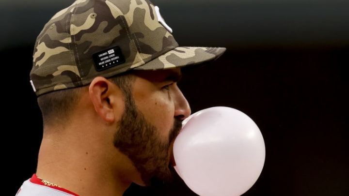 Cincinnati Reds' Eugenio Suarez blows a bubble with his gum as he