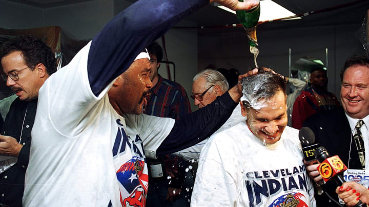 Jose Mesa of the Cleveland Indians pours champagne over Omar Vizquel''s head.