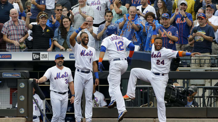 NEW YORK, NEW YORK – SEPTEMBER 12: Juan Lagares #12 of the New York Mets celebrates his third inning grand slam home run against the Arizona Diamondbacks with teammates Amed Rosario #1 and Robinson Cano #24 and manager Mickey Callaway #36 at Citi Field on September 12, 2019 in New York City. (Photo by Jim McIsaac/Getty Images)