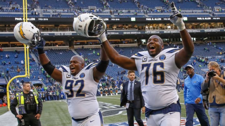 SEATTLE, WA - NOVEMBER 04: Brandon Mebane #92 and Russell Okung #76 of the Los Angeles Chargers head off the field following the game against the Seattle Seahawks at CenturyLink Field on November 4, 2018 in Seattle, Washington. (Photo by Otto Greule Jr/Getty Images)