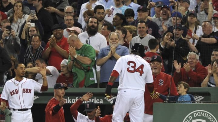May 12, 2016; Boston, MA, USA; Boston Red Sox designated hitter David Ortiz (34) high fives a fan after scoring a run during the third inning against the Houston Astros at Fenway Park. Mandatory Credit: Bob DeChiara-USA TODAY Sports