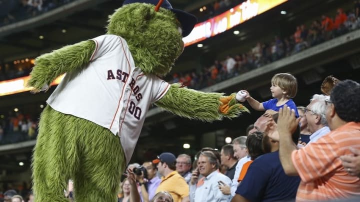 May 10, 2016; Houston, TX, USA; Houston Astros mascot "Orbit" gives a ball to a fan during the eighth inning of a game against the Cleveland Indians at Minute Maid Park. Mandatory Credit: Troy Taormina-USA TODAY Sports