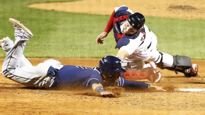 BOSTON, MASSACHUSETTS - AUGUST 10: Kevin Plawecki #25 of the Boston Red Sox tags out Michael Perez #7 of the Tampa Bay Rays at home plate at the top of the fourth inning of the game at Fenway Park on August 10, 2020 in Boston, Massachusetts. (Photo by Omar Rawlings/Getty Images)