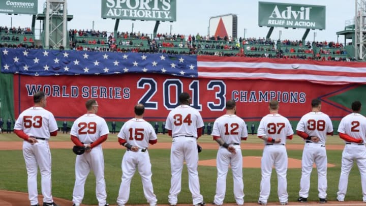 BOSTON, MA - APRIL 4: Members of the Boston Red Sox stand for the National Anthem during a ceremony honoring the 2013 World Series Champion Boston Red Sox before the start of a game against the Milwaukee Brewers at Fenway Park on April 4, 3014 in Boston, Masschusetts. (Photo by Michael Ivins/Boston Red Sox/Getty Images)