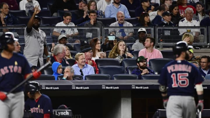 NEW YORK, NY - SEPTEMBER 01: A Yankee fan (L) heckles Dustin Pedroia