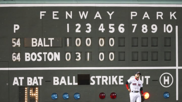 BOSTON, MA - SEPTEMBER 22: Michael Chavis #23 of the Boston Red Sox reacts after misjudging a ball hit by the Green Monster scoreboard in the sixth inning of a game against the Baltimore Orioles at Fenway Park on September 22, 2020 in Boston, Massachusetts. (Photo by Adam Glanzman/Getty Images)