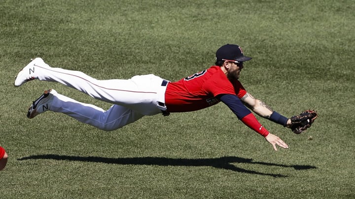 BOSTON, MA – JULY 28: Michael Chavis #23 of the Boston Red Sox makes a diving catch on Vladimir Guerrero Jr. #27 of the Toronto Blue Jays during the third inning of the first game of a doubleheader at Fenway Park on July 28, 2021 in Boston, Massachusetts. (Photo By Winslow Townson/Getty Images)