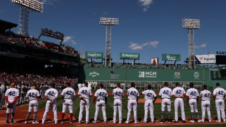 BOSTON, MASSACHUSETTS - APRIL 15: Members of the Boston Red Sox stand on the first base line on Opening Day at Fenway Park on April 15, 2022 in Boston, Massachusetts. All players are wearing the number 42 in honor of Jackie Robinson Day. (Photo by Maddie Meyer/Getty Images)