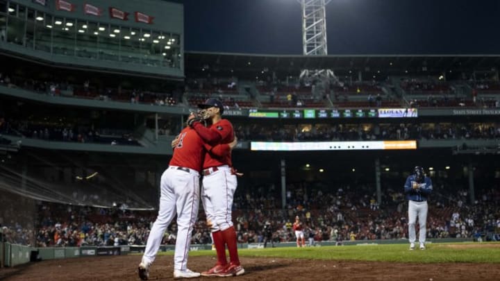 BOSTON, MA - OCTOBER 5: Xander Bogaerts #2 of the Boston Red Sox hugs Rafael Devers #11 as he exits the game during the seventh inning of a game against the Tampa Bay Rays on October 5, 2022 at Fenway Park in Boston, Massachusetts. (Photo by Billie Weiss/Boston Red Sox/Getty Images)