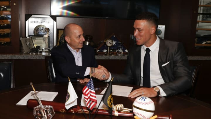 NEW YORK, NY - DECEMBER 21: General manager Brian Cashman of the New York Yankees and Aaron Judge #99 finalize Judges nine-year contract before a press conference at Yankee Stadium on December 21, 2022 in the Bronx, New York. (Photo by New York Yankees/Getty Images)