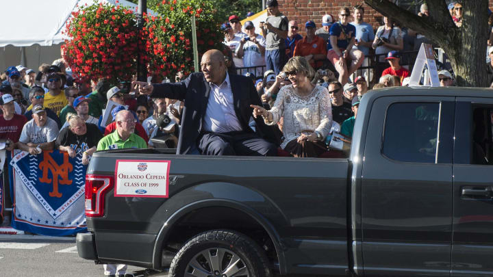 Jul 23, 2016; Cooperstown, NY, USA; Hall of Famer Orlando Cepeda and his wife during the MLB baseball hall of fame parade of legends at National Baseball Hall of Fame. Mandatory Credit: Gregory J. Fisher-USA TODAY Sports