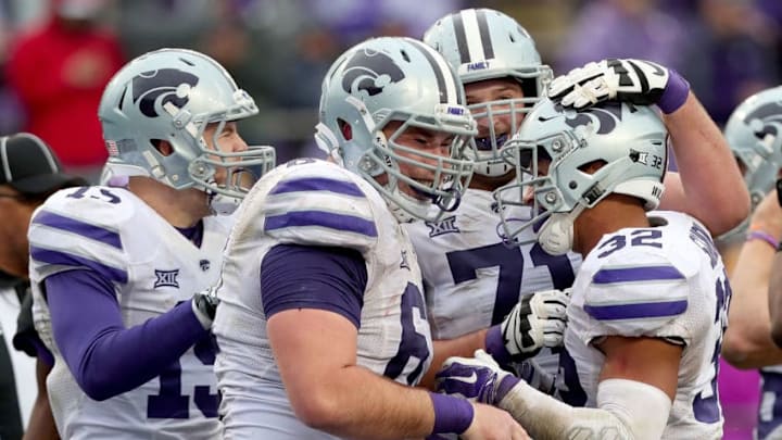 FORT WORTH, TX - DECEMBER 03: Justin Silmon #32 of the Kansas State Wildcats celebrates with Dalton Risner #71 of the Kansas State Wildcats, Reid Najvar #67 of the Kansas State Wildcats and Zach Reuter #15 of the Kansas State Wildcats after scoring a touchdown against the TCU Horned Frogs at Amon G. Carter Stadium on December 3, 2016 in Fort Worth, Texas. (Photo by Tom Pennington/Getty Images)
