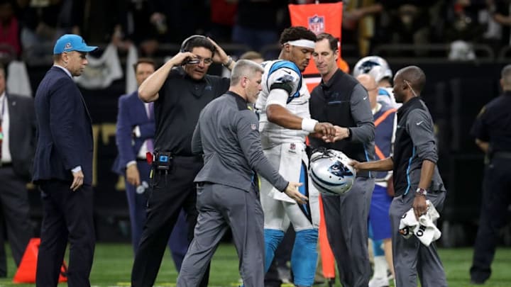 NEW ORLEANS, LA - JANUARY 07: Cam Newton #1 of the Carolina Panthers is checked on the sideline after a tackle during the game against the New Orleans Saints at the Mercedes-Benz Superdome on January 7, 2018 in New Orleans, Louisiana. (Photo by Chris Graythen/Getty Images)