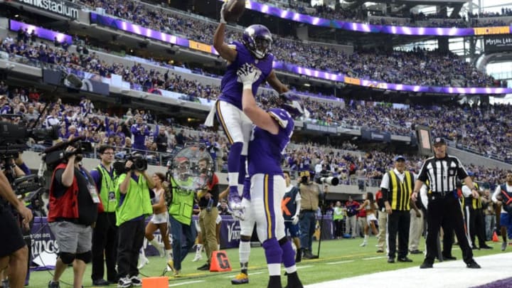 MINNEAPOLIS, MN - JANUARY 1: Jarius Wright #17 and Jeremiah Sirles #78 of the Minnesota Vikings celebrate after Wright scored a touchdown in the second quarter of the game against the Chicago Bears on January 1, 2017 at US Bank Stadium in Minneapolis, Minnesota. (Photo by Hannah Foslien/Getty Images)