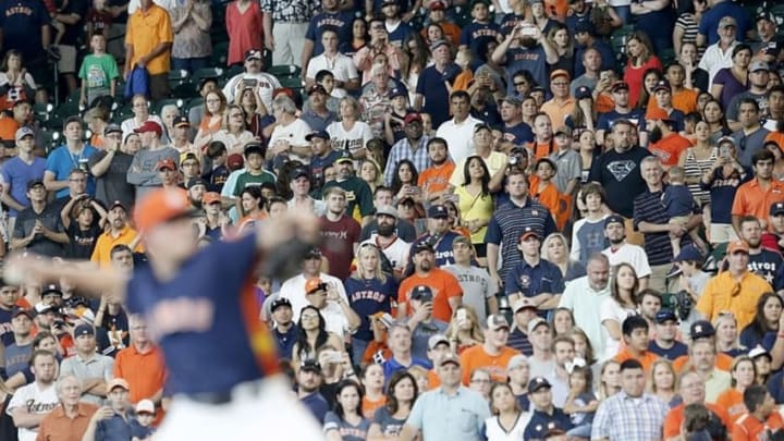Jun 5, 2016; Houston, TX, USA; Fans applaud as Houston Astros relief pitcher Will Harris (36) pitches against the Oakland Athletics in the ninth inning at Minute Maid Park. Astros won 5-2. Mandatory Credit: Thomas B. Shea-USA TODAY Sports
