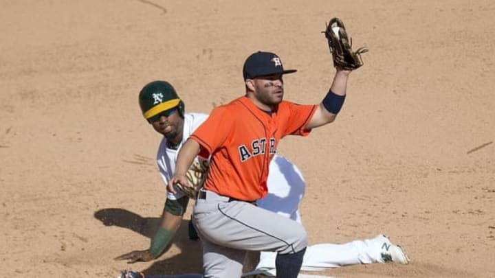 Sep 21, 2016; Oakland, CA, USA; Oakland Athletics first baseman Yonder Alonso (17) is tagged out on an attempted steal by Houston Astros second baseman Jose Altuve (27) during the ninth inning to end the game at Oakland Coliseum. The Astros won, 6-5. Mandatory Credit: Kenny Karst-USA TODAY Sports