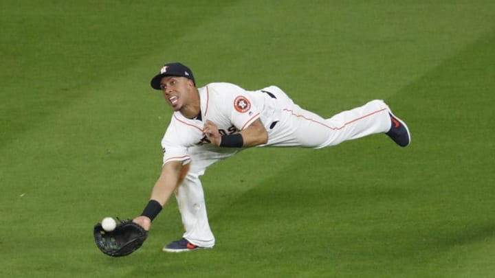 HOUSTON, TX - OCTOBER 19: Michael Brantley #23 of the Houston Astros makes a diving catch in the seventh inning against the New York Yankees during Game Six of the League Championship Series at Minute Maid Park on October 19, 2019 in Houston, Texas. (Photo by Tim Warner/Getty Images)