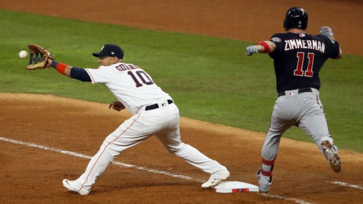 HOUSTON, TEXAS - OCTOBER 23: Ryan Zimmerman #11 of the Washington Nationals is thrown out as Yuli Gurriel #10 of the Houston Astros makes the catch during the sixth inning in Game Two of the 2019 World Series at Minute Maid Park on October 23, 2019 in Houston, Texas. (Photo by Bob Levey/Getty Images)