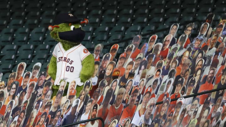 HOUSTON, TEXAS - AUGUST 12: Houston Astros mascot Orbit wears a mask while standing in a crowd of fan cut-outs during the game against the San Francisco Giants at Minute Maid Park on August 12, 2020 in Houston, Texas. (Photo by Tim Warner/Getty Images)