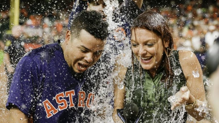 HOUSTON, TX - AUGUST 06: Juan Centeno #30 of the Houston Astros and AT&T SportsNet sideline reporter Julia Morales are doused with water from Collin McHugh during a post game interview at Minute Maid Park on August 6, 2017 in Houston, Texas. Centeno hit a walkoff single in the ninth inning against the Toronto Blue Jays. (Photo by Bob Levey/Getty Images)