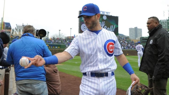 Apr 28, 2016; Chicago, IL, USA; Chicago Cubs third baseman Tommy La Stella (2) hands a fan a ball prior to a game against the Milwaukee Brewers at Wrigley Field. Cubs won 7-2. Mandatory Credit: Patrick Gorski-USA TODAY Sports