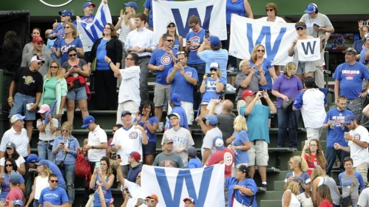 Sep 23, 2016; Chicago, IL, USA; Fans in the bleachers celebrate the Chicago Cubs win against the St. Louis Cardinals at Wrigley Field. The Cubs won 5-0. Mandatory Credit: David Banks-USA TODAY Sports