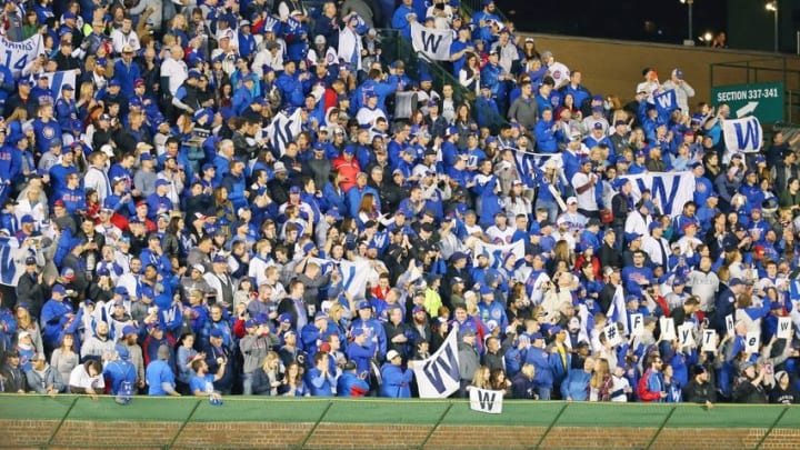Oct 8, 2016; Chicago, IL, USA; Fans hold up "W" flags after the Chicago Cubs beat the San Francisco Giants in game two of the 2016 NLDS playoff baseball series at Wrigley Field. The Chicago Cubs won 5-2. Mandatory Credit: Jerry Lai-USA TODAY Sports