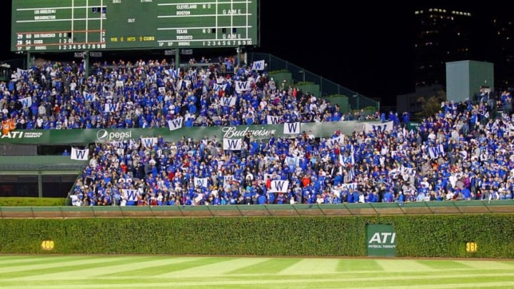 Oct 8, 2016; Chicago, IL, USA; Fans hold up "W" flags after the Chicago Cubs beat the San Francisco Giants in game two of the 2016 NLDS playoff baseball series at Wrigley Field. Mandatory Credit: Dennis Wierzbicki-USA TODAY Sports