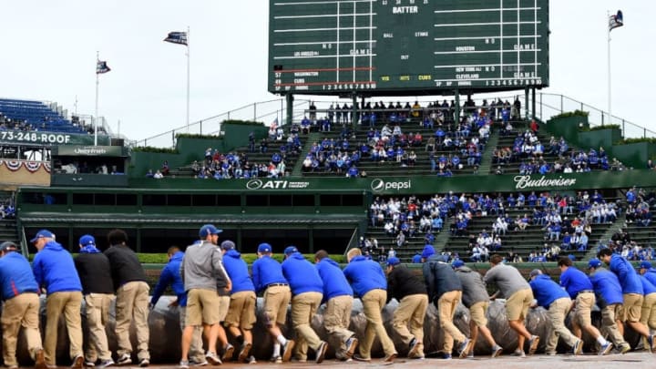 CHICAGO, IL - OCTOBER 10: Members of the grounds crew cover the infield with a tarp before game four of the National League Division Series between the Washington Nationals and the Chicago Cubs at Wrigley Field on October 10, 2017 in Chicago, Illinois. (Photo by Stacy Revere/Getty Images)