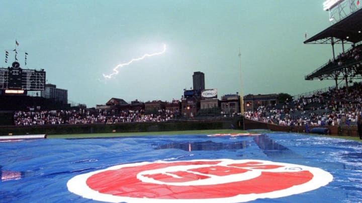 A tarp covers the field as rain and lightening delay the Houston Astros game against the Chicago Cubs at Wrigley Field 24 August in Chicago, IL. Despite the delay the Astros defeated the Cubs Chicago Cubs (Photo by DANIEL LIPPITT/AFP via Getty Images)