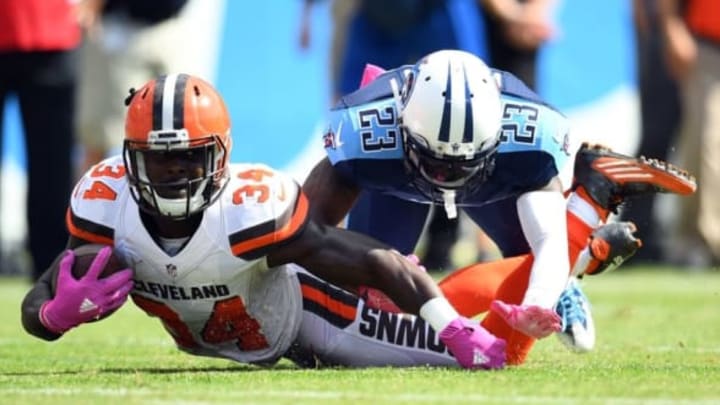 Oct 16, 2016; Nashville, TN, USA; Cleveland Browns running back Isaiah Crowell (34) is tackled by Tennessee Titans cornerback Bennett Okotcha (23) after a short gain in the first half at Nissan Stadium. Mandatory Credit: Christopher Hanewinckel-USA TODAY Sports