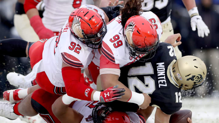 BOULDER, CO – NOVEMBER 17: Quarterback Steven Montez #12 of the Colorado Buffaloes is is sacked by Maxs Tupai #92, Leki Fotu #99 and John Penisini #52 of the Utah Utes in the fourth quarter at Folsom Field on November 17, 2018 in Boulder, Colorado. (Photo by Matthew Stockman/Getty Images)