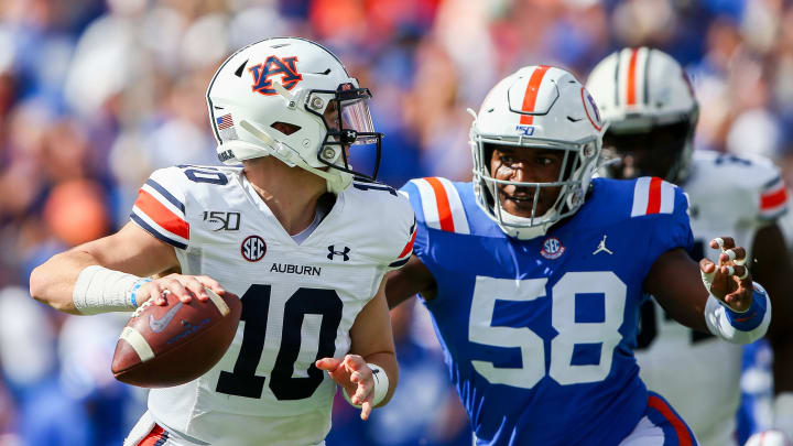 GAINESVILLE, FLORIDA – OCTOBER 05: Bo Nix #10 of the Auburn Tigers is pressured by Jonathan Greenard #58 of the Florida Gators during the first quarter of a game at Ben Hill Griffin Stadium on October 05, 2019 in Gainesville, Florida. (Photo by James Gilbert/Getty Images)