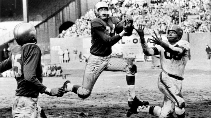 Detroit Lions Hall of Fame safety Jack Christiansen intercepts Cleveland Browns Hall of Fame quarterback Otto Grahams pass to Hall of Fame wide receiver Dante Lavelli in a 56-10 loss to the Cleveland Browns in a League Championship game on December 26, 1954 at Cleveland Municipal Stadium in Cleveland, Ohio. (Photo by Tim Culek/Getty Images)