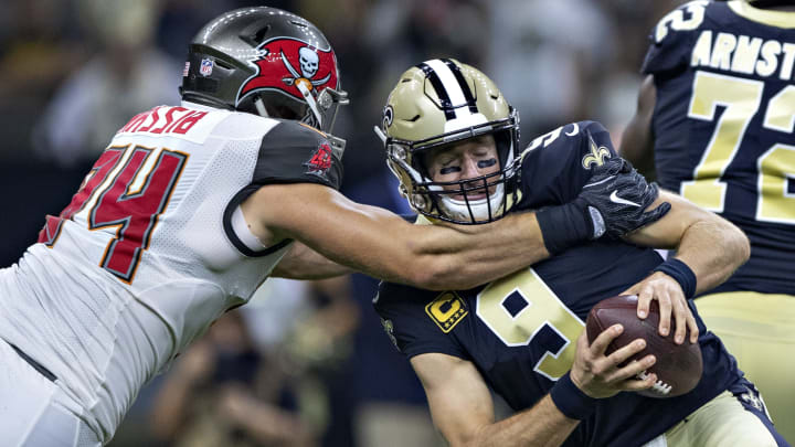 NEW ORLEANS, LA – SEPTEMBER 9: Drew Brees #9 of the New Orleans Saints is grabbed in the second quarter by Carl Nassib #94 of the Tampa Bay Buccaneers at Mercedes-Benz Superdome on September 9, 2018 in New Orleans, Louisiana. (Photo by Wesley Hitt/Getty Images)