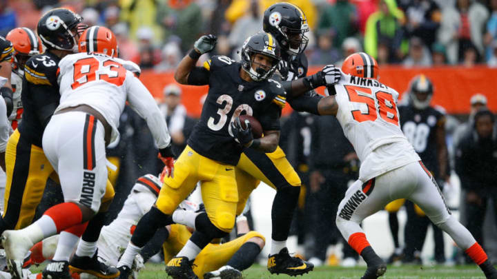 CLEVELAND, OH - SEPTEMBER 09: James Conner #30 of the Pittsburgh Steelers rushes past the defense of Trevon Coley #93 and Christian Kirksey #58 of the Cleveland Browns for a touchdown during the third quarter at FirstEnergy Stadium on September 9, 2018 in Cleveland, Ohio. (Photo by Joe Robbins/Getty Images)