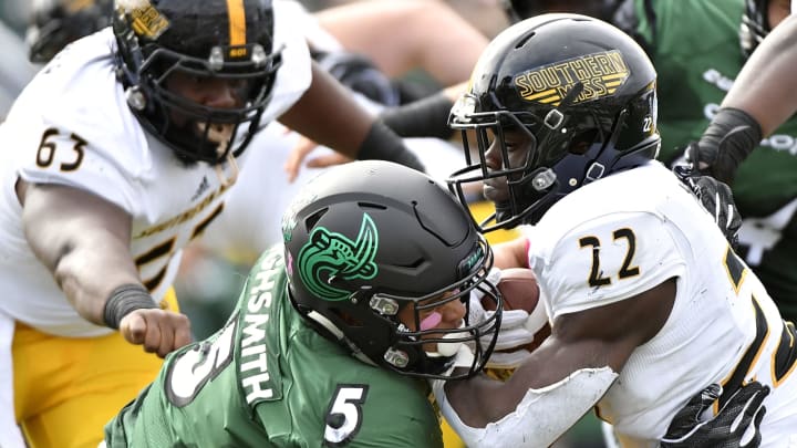 CHARLOTTE, NC – OCTOBER 27: Defensive end Alex Highsmith #5 of the Charlotte 49ers tackles running back Trivenskey Mosley #22 of the Southern Miss Golden Eagles during the football game at Jerry Richardson Stadium on October 27, 2018 in Charlotte, North Carolina. (Photo by Mike Comer/Getty Images)