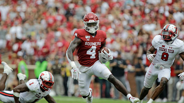 NORMAN, OK – SEPTEMBER 28: Running back Trey Sermon #4 of the Oklahoma Sooners splits the defense of the Texas Tech Red Raiders at Gaylord Family Oklahoma Memorial Stadium on September 28, 2019 in Norman, Oklahoma. The Sooners defeated the Red Raiders 55-16. (Photo by Brett Deering/Getty Images)